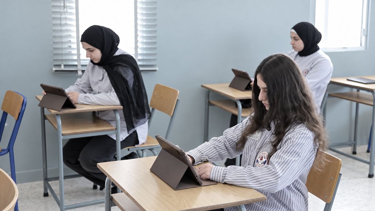 Students working on tablets in an AMC classroom