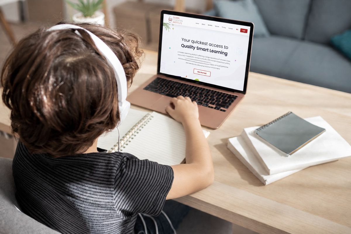 A student learning at home on a laptop with the Global Education Institute platform open